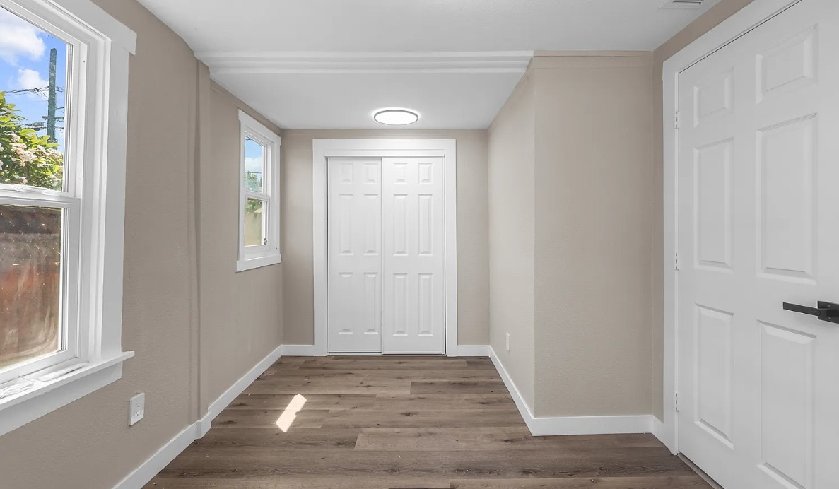 Hallway with new doors, trim, and wood-look flooring