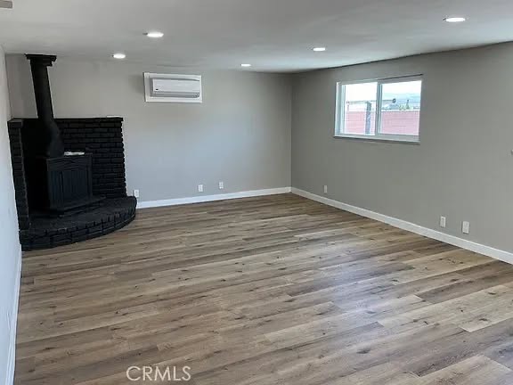 Living room with new flooring, recessed lighting, and fresh paint