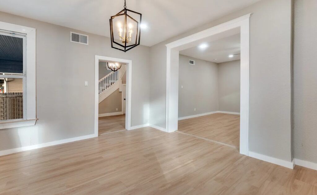 Renovated dining room with new flooring, trim and pendant light