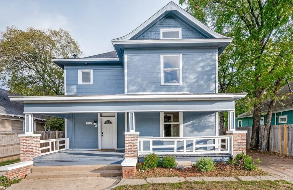 Renovated two-story craftsman home with blue siding and a new front porch