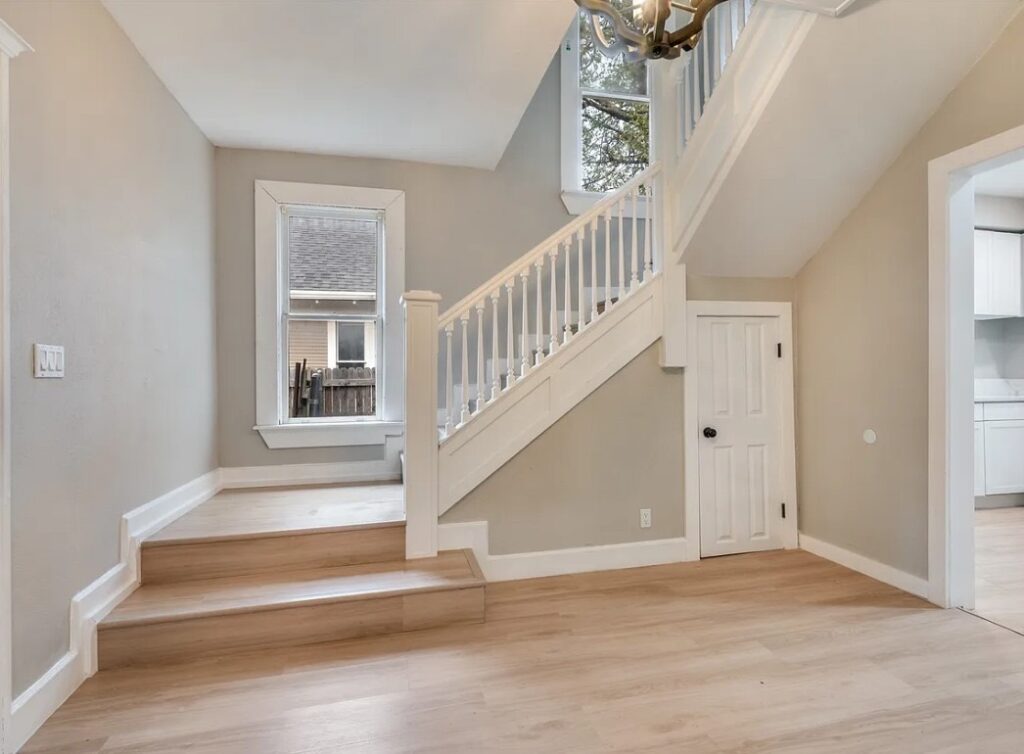 Renovated entry with refinished staircase and new flooring